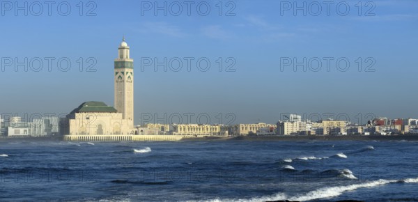 Hassan II mosque in Casablanca and Atlantic ocean waves at sunset, Morocco, panorama, Africa