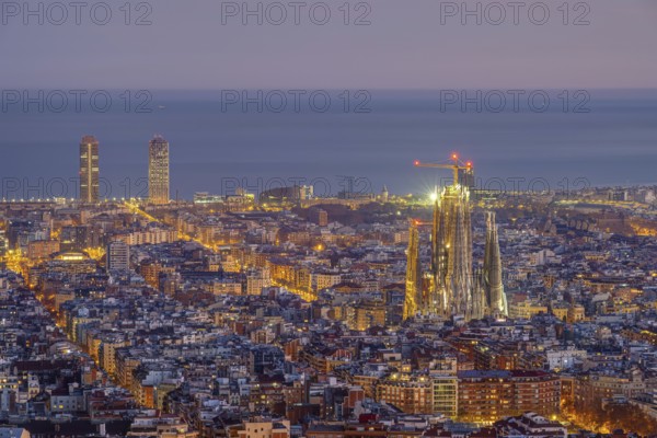 The skyline of Barcelona city centre with the Sagrada Familia in front of sunrise