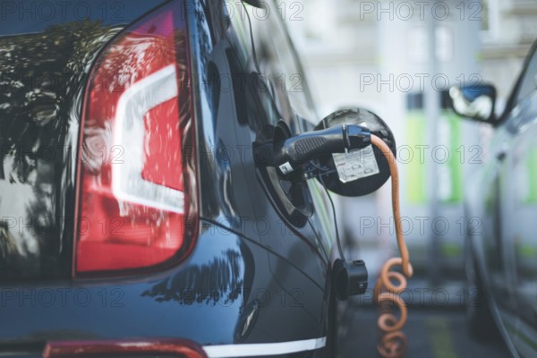 Electric car recharging with charge cable and plug leading to charge point