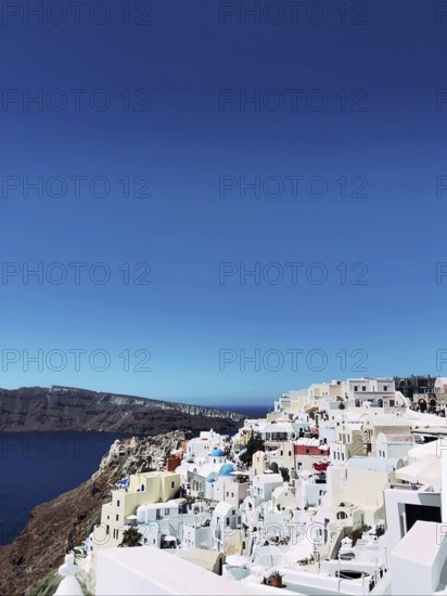 Amazing panorama view of beautiful Oia town on Santorini volcanic island, Greece, Aegean Sea.