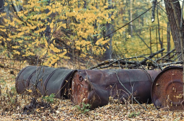 Barrels of chemical waste in the forest in Chernobyl Ukraine in autumn