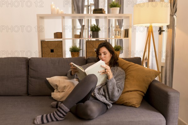 Young woman reading living room