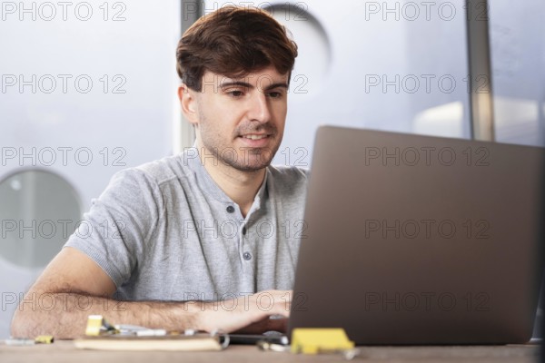 Man working as lancer home his laptop