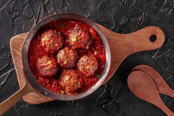 Meatballs. Beef meat balls, overhead flat lay shot in a pan, with parsley and tomato sauce, on a
