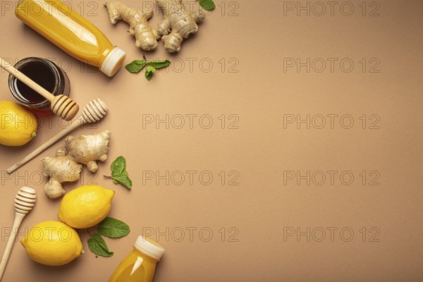 Orange detox drink, lemons, mint, ginger, honey in glass jar, honey wooden dippers top view. Food