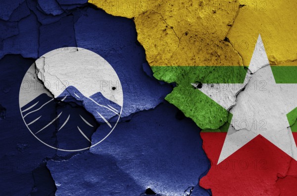Flags of Kachin State and Myanmar painted on cracked wall