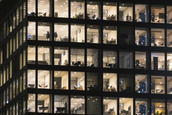 The lights in the offices of the Omni Tower in Frankfurt am Main glow in the evening. Frankfurt am