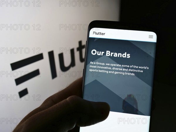 Stuttgart, Germany, 01-06-2022: Person holding smartphone with webpage of Irish bookmaking company