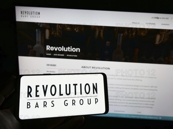 Stuttgart, Germany, 01-25-2023: Person holding smartphone with logo of hospitality company
