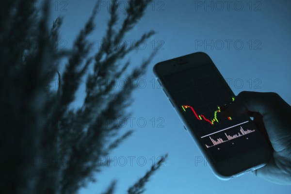 Woman holding mobile phone, block chain with graph of stock market background, cryptocurrencies or