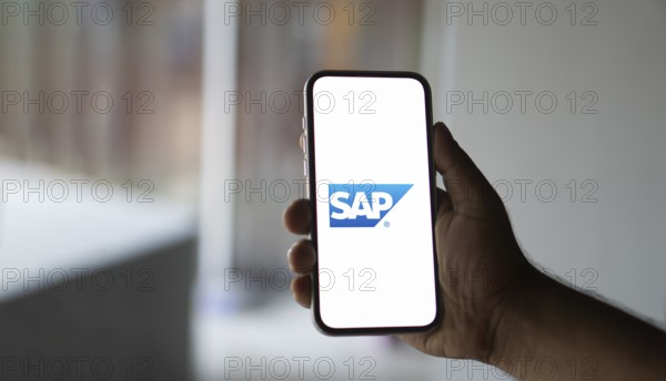 SAP SE logo is displayed on smartphone. SAP SE is a German multinational software company based in