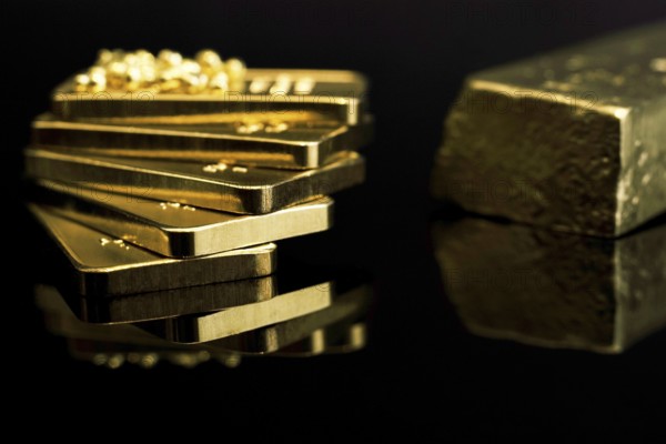 Gold bars 999 precious metal, black background