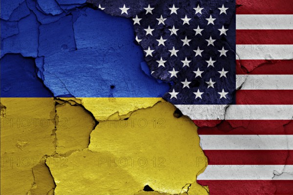 Flags of Ukraine and USA painted on cracked wall