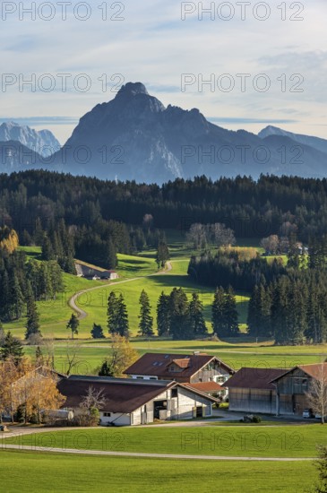Farms, autumnal meadows and forests near Seeg with the Säuling mountain in the background, Allgäu,