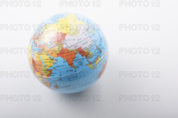 Little model globe on white background in view