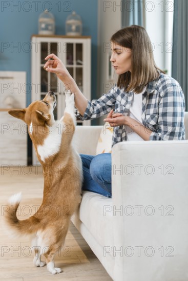 Woman couch giving her dog treat