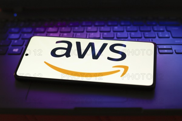(AWS) logo is displayed on a smartphone screen