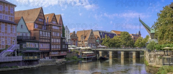 Lüneburg harbour at the Illmenau with old Hanseatic wooden boats, surrounding buildings of the