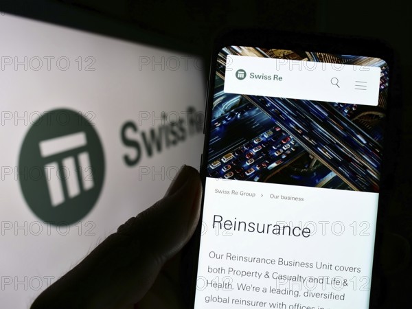 Stuttgart, Germany, 10-24-2022: Person holding cellphone with webpage of reinsurance company Swiss