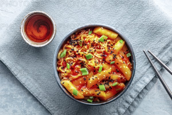 Rabokki, tteokbokki or topokki with ramen, Korean street food, spicy rice cakes, overhead flat lay