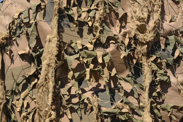 A drab background of army camouflage netting