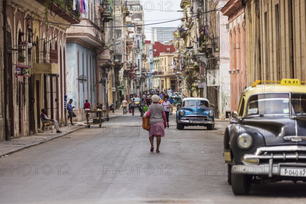 Street scene with vintage taxi car in the old part of the Havana