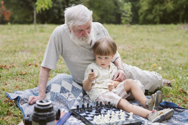 Front view grandson sitting with grandpa