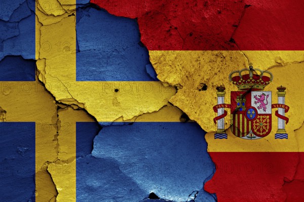 Flags of Sweden and Spain painted on cracked wall