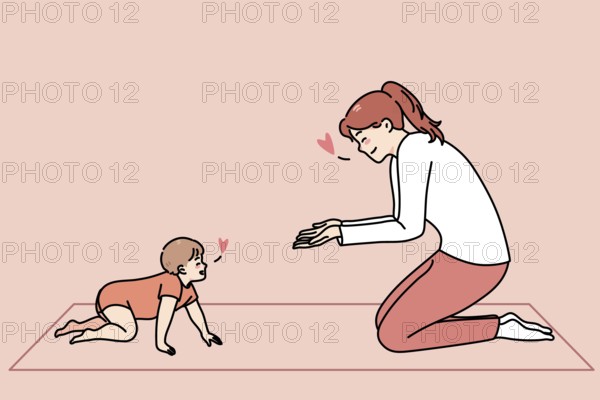 Loving happy young mother play with little toddler crawling at home. Smiling caring mom have fun
