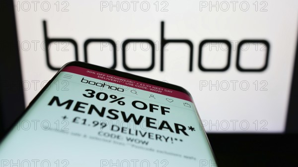 Stuttgart, Germany, 05-28-2022: Mobile phone with website of British fashion company Boohoo Group