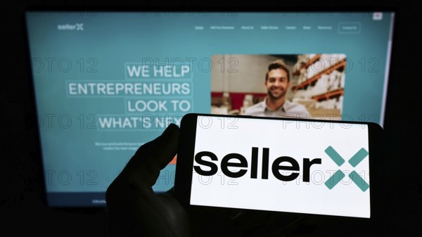 Stuttgart, Germany, 05-08-2022: Person holding cellphone with logo of e-commerce company SellerX