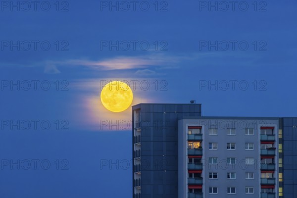 Rising full moon over 17-storey prefabricated buildings in Dresden Johannstadt, Full moon over