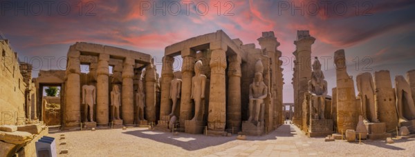 Sculptures of ancient Egyptian pharaohs and drawings on the columns of the Luxor Temple in the