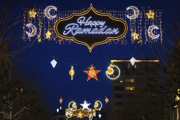 The illuminated lettering Happy Ramadan shines on the evening of 10 March 2024 as part of a light