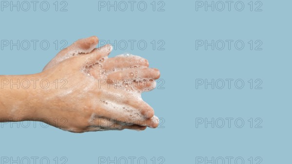 Sideways person washing hands with copy space