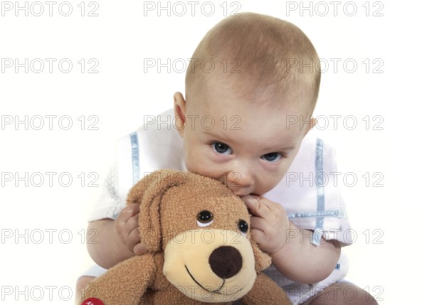 BABY, BOY PLAYING WITH A SOFT TOY