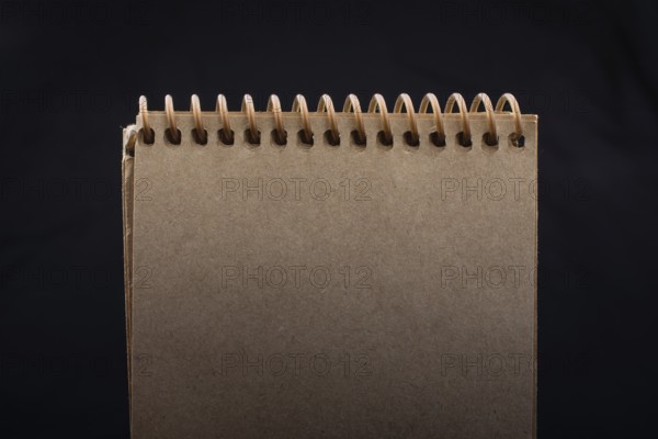 White notebook on a black color background inthe view