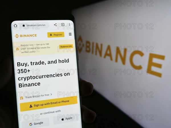 Stuttgart, Germany, 03-31-2023: Person holding cellphone with webpage of crypto exchange company