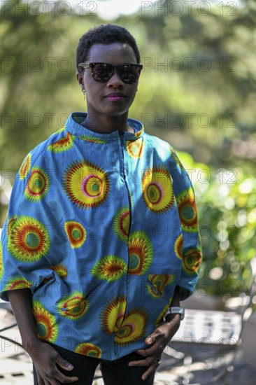 Young adult afro hair diverse black model pose outdoors in african print attire wear sunglasses