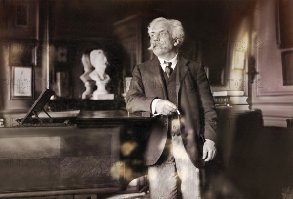 Gabriel Fauré, 1845 – 1924, French composer, next to his piano in his appartement, Boulevard
