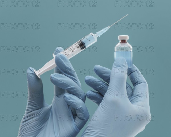 Vaccine bottle syringe held by doctor with gloves. Resolution and high quality beautiful photo