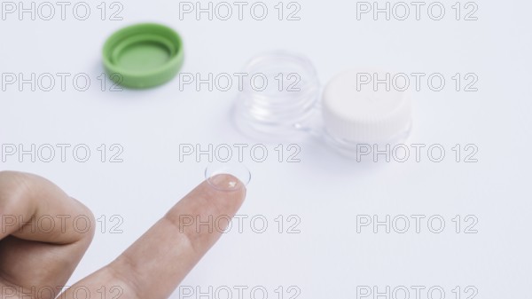 Female showing contact lenses his finger. Resolution and high quality beautiful photo