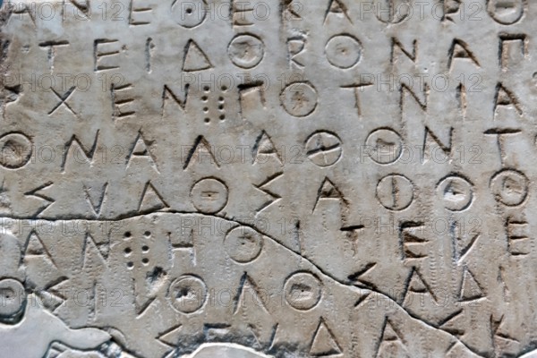 Ancient greek letters in stone abstract background