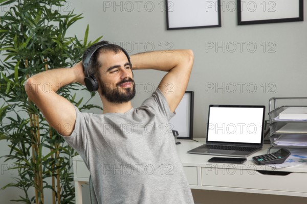 Man using headphones while working from home