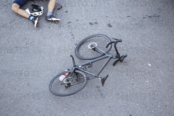 Bicycle accident on the road. Scene of a cyclist and bicycle on the asphalt after being hit by a