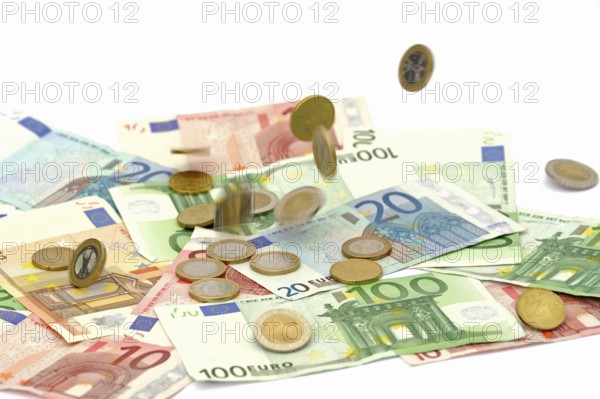 Euro coins fall on euro banknotes, rain of money, high cost, symbolic image