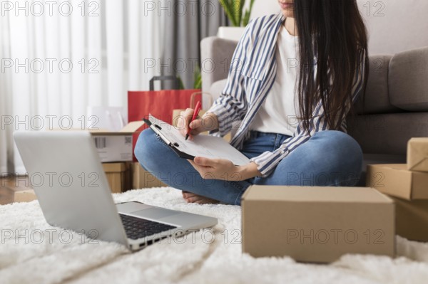 Woman taking notes about cyber monday purchases