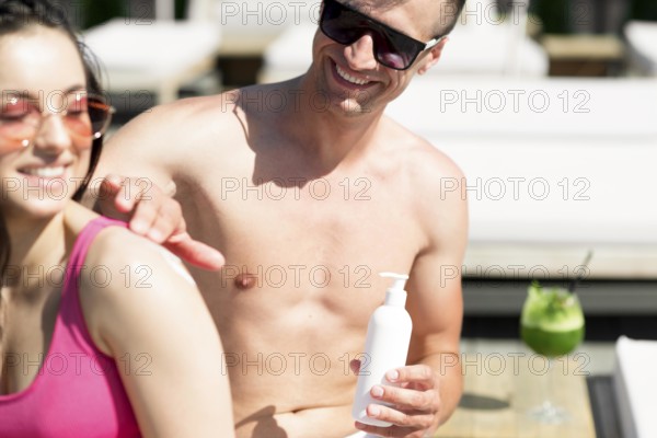 Cute couple beach with sunscreen