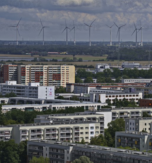 Residential buildings on the outskirts of the city, in the background wind turbines outside the