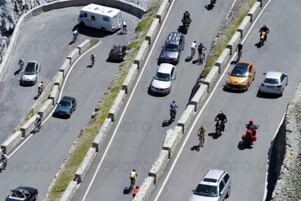 Stelvio Pass, much traffic in the summer season, busy and crowded with pedestrians, bikers, cars,